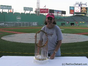 Boston Red Soxs' Johnny Damon holds the World Championship trophy