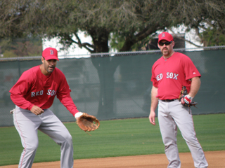 Continuing my series of photos of Great Fu Manchus in Red Sox History, it's Kevin Youkilis, sporting his new look. He's joined by Mike Lowell (whose hip looked fine, by the way) taking ground balls at third.