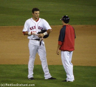 Aaron Bates, who had spent a week in Boston before the All-Star vreak, hands off his helmet and gloves after running the bases in the fifth. His fourth-inning home run gave the PawSox their first run of the game.