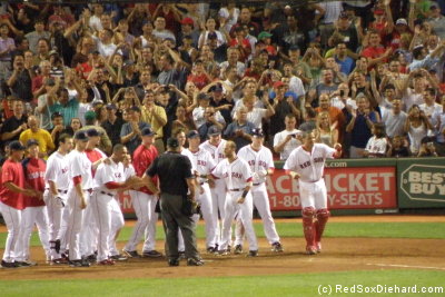 Big Papi's teammates assemble at home plate, ready to pounce.