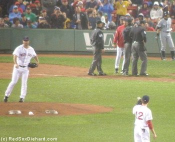 While Wakefield makes his warmup tosses between innings, Tito is in a "discussion" with the umpiring crew.