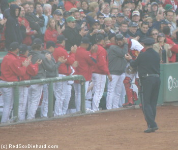 Tek is congratulated by his teammates and the fans as he leaves the game in the top of the ninth.
