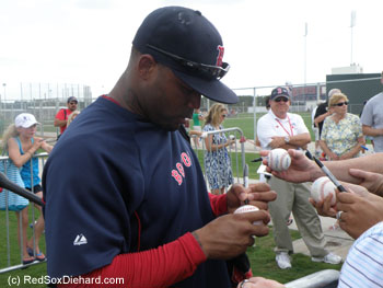 Carl Crawford signs autographs after practice.