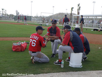 Jose Iglesias talks with coaches Tim Bogar and Jerry Royster and manager Bobby Valentine.