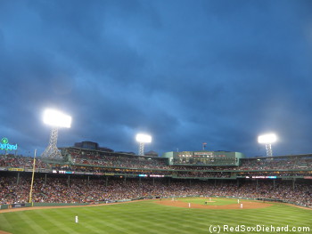 Dark clouds and the threat of rain hung over the ballpark all night.