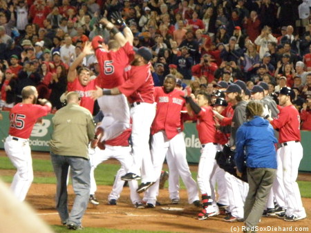Jonny Gomes leaps into a sea of happy teammates after his game-winning blast.