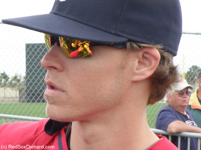 Brock Holt's sunglasses reflect baseballs and sharpies as he signed autographs after practice again.