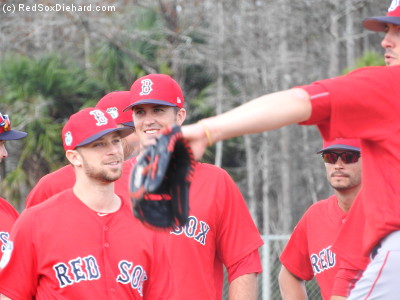 Tyler Thornburg, Drew Pomeranz, and Joe Kelly wait in line for their turn. First they all practiced fielding a balla dn throwing to first base, then to second base, then to third, and then to home.
