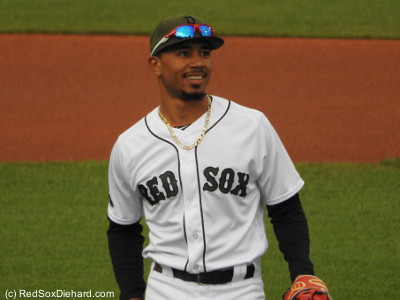 Mookie Betts takes the field with a smile in the top of the first. 