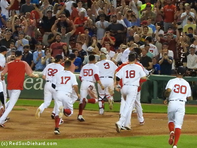 Hanley scoops Pedey up into his arms (just beyond #18 Moreland) as the rest of the team catches up.