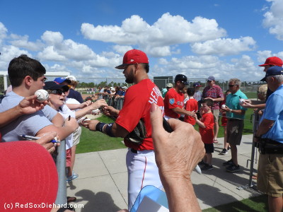 Several players signed autographs after practice. Here, catchers Oscar Hernandez and Dan Butler interact with the fans. 